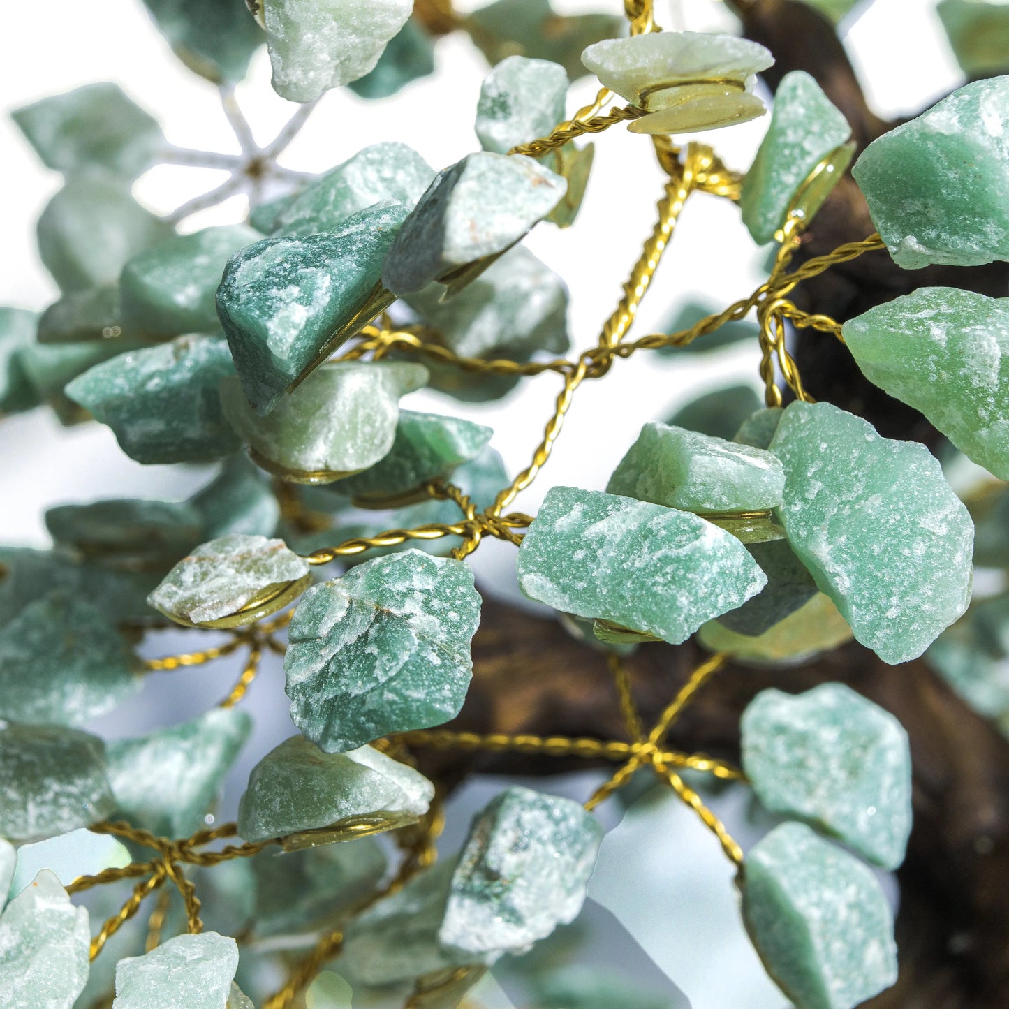 Close-up of handcrafted Rough Aventurine Crystal Bonsai Tree, highlighting green stones with golden wires for prosperity and harmony.