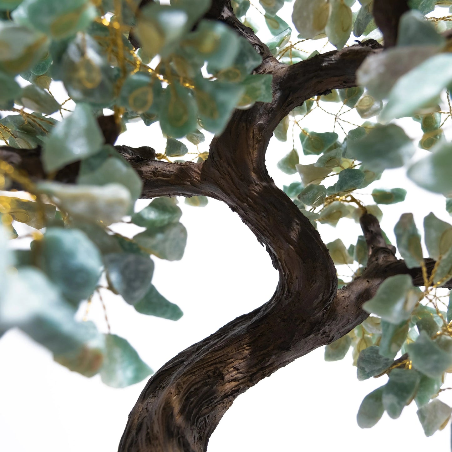 Close-up of Rough Aventurine Tree with handcrafted leaves, symbolizing prosperity and positive energy, on a curved trunk.