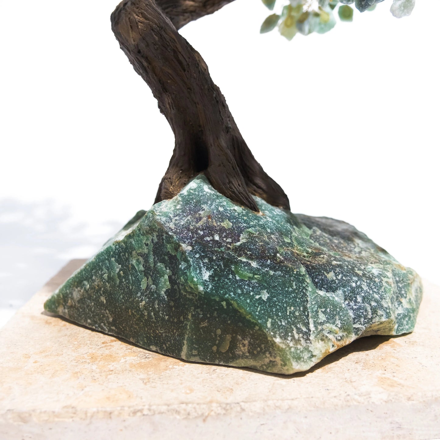 Base of handcrafted Rough Aventurine Tree showcasing green crystal used for harmony and prosperity, 65 cm tall.