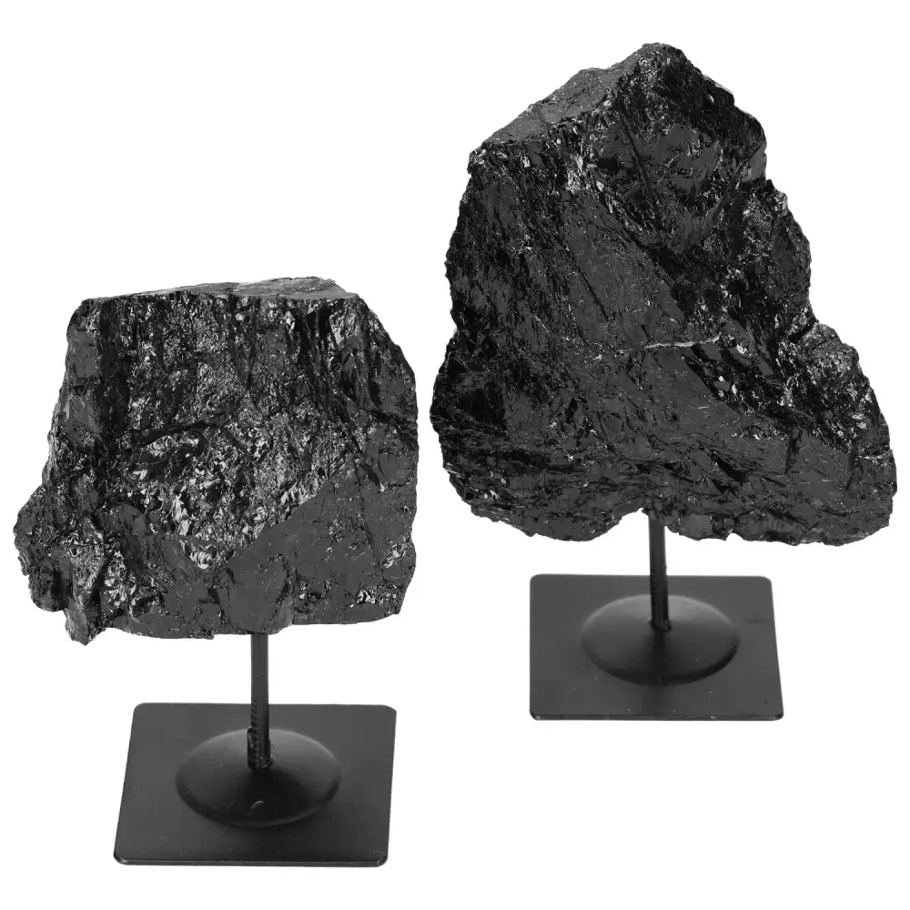 Rough black tourmaline on metal stand from Sylvia Crystals, known for protection and grounding energy, absorbs negative energies.