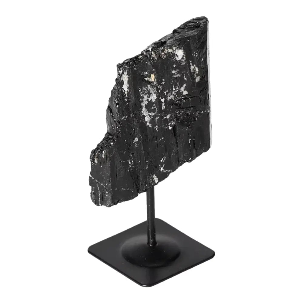 Rough Black Tourmaline on metal stand, premium natural healing crystal for cleansing and renewal, by Sylvia Crystals.