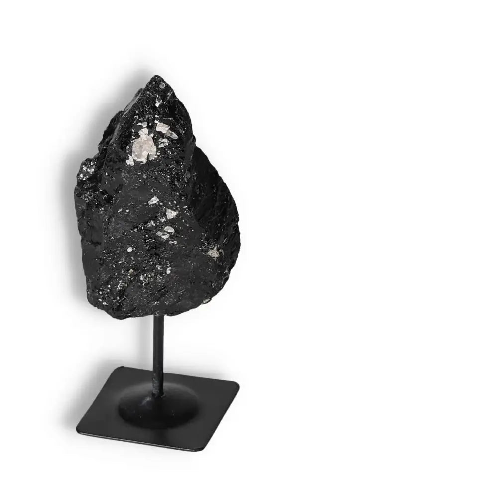 Rough Black Tourmaline crystal on metal stand, exuding luxury and spiritual elegance, ideal for cleansing and transforming negative energies.
