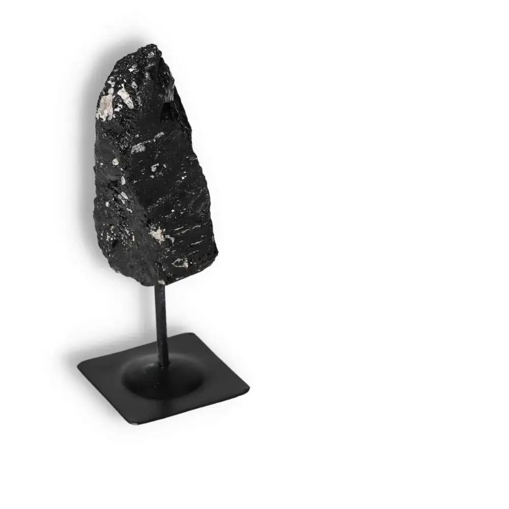 Rough Black Tourmaline on a metal stand from Sylvia Crystals, showcasing natural elegance and energy cleansing properties.