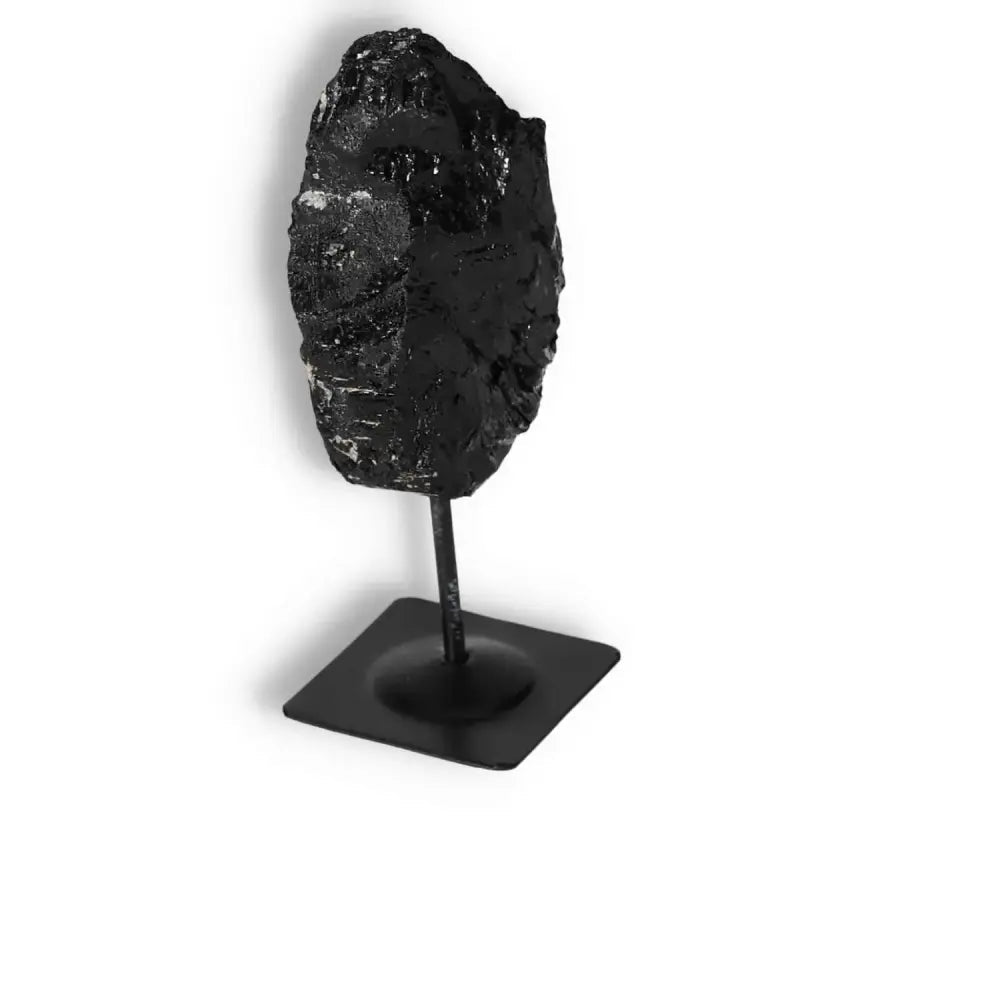 Rough Black Tourmaline on metal stand, premium crystal for cleansing negative energies, spiritual elegance by Sylvia Crystals.