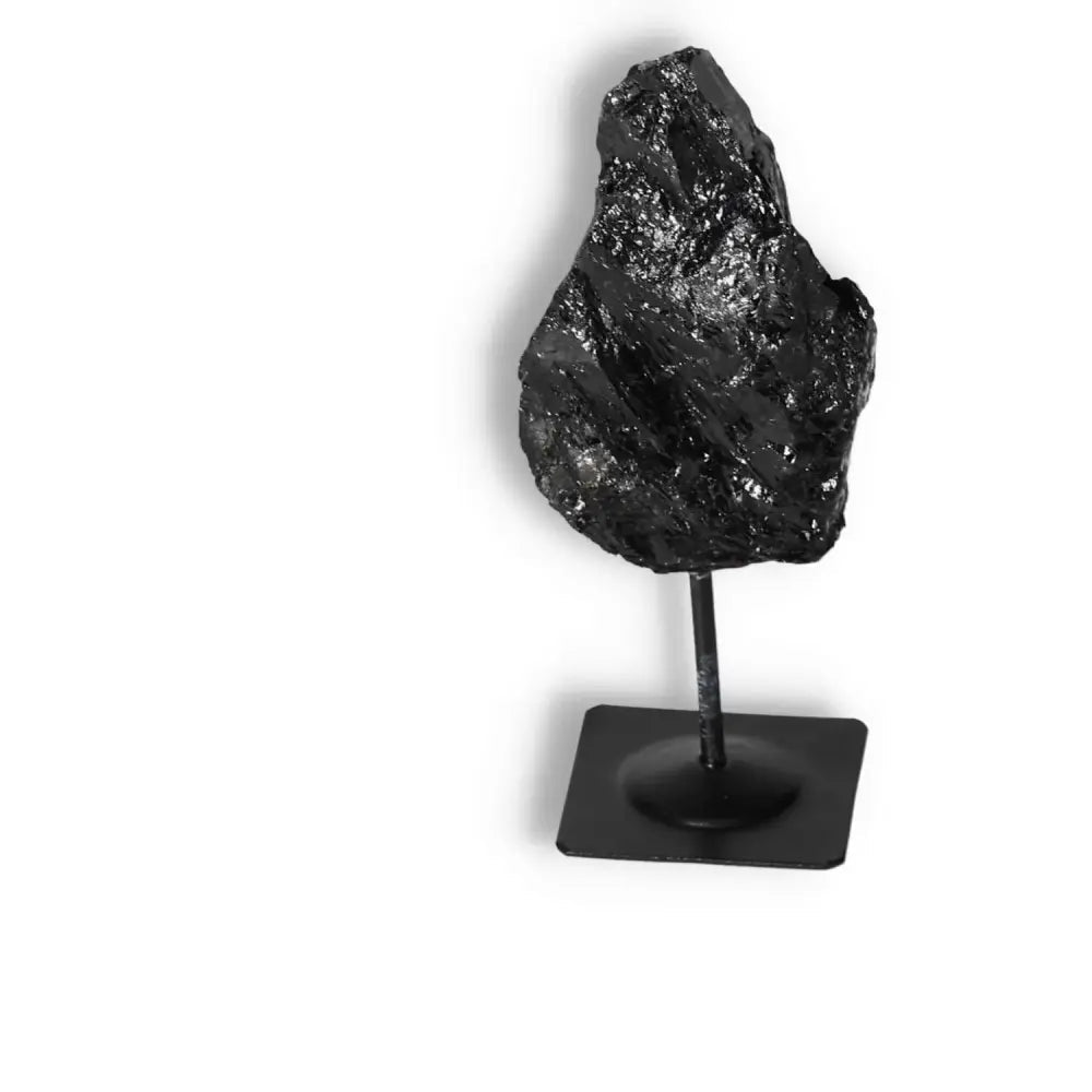 Rough Black Tourmaline on metal stand from Sylvia Crystals, ideal for energy cleansing and spiritual elegance.