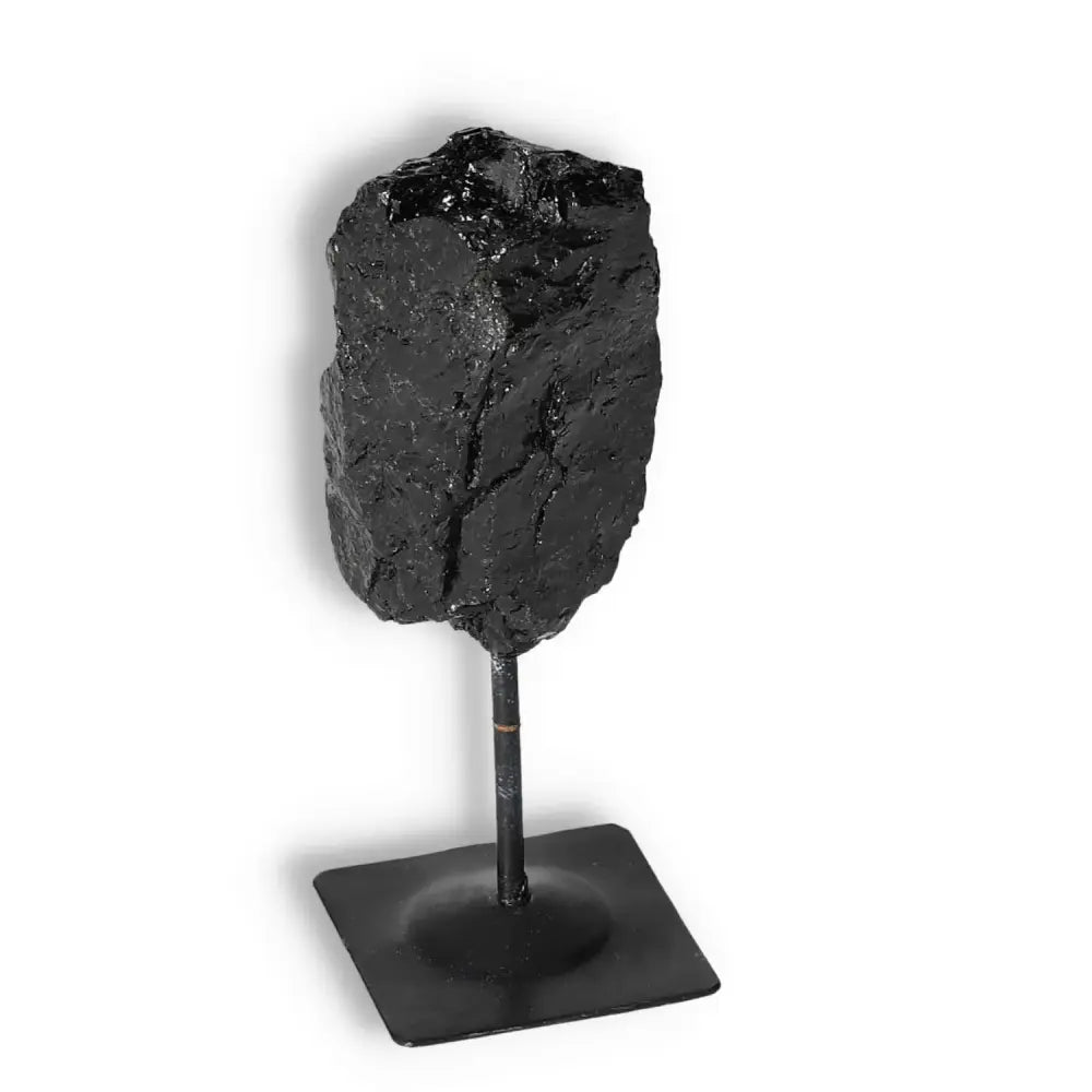 Rough Black Tourmaline on Metal Stand S from Sylvia Crystals, known for cleansing negative energies and enhancing environments.