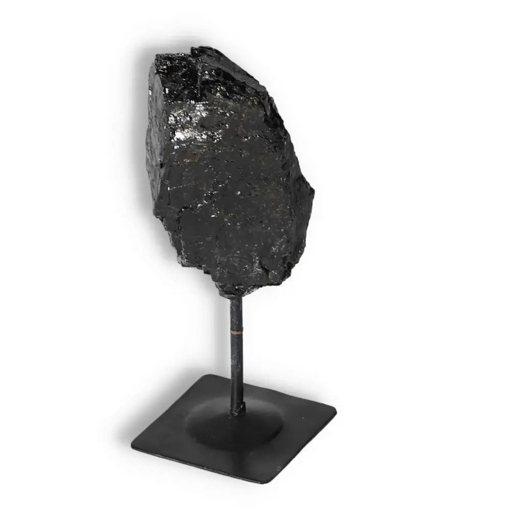 Rough Black Tourmaline on Metal Stand S, product by Sylvia Crystals known for purifying negative energies, enhancing space decor.