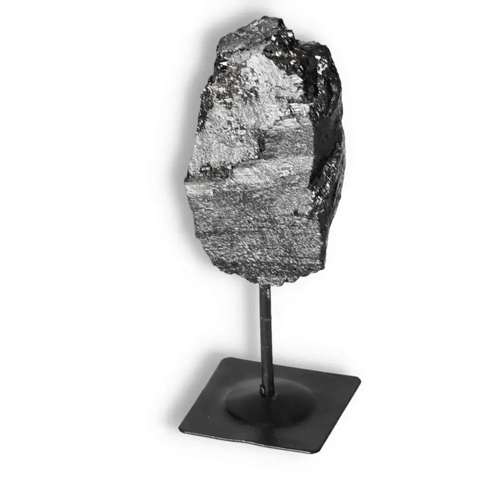 Rough Black Tourmaline with Metal Stand S from Sylvia Crystals, known for purifying energies and enhancing any environment.