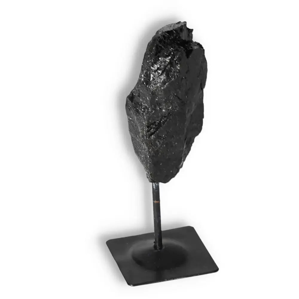 Rough Black Tourmaline on Metal Stand S, showcasing its raw beauty and energy-cleansing properties from Sylvia Crystals.