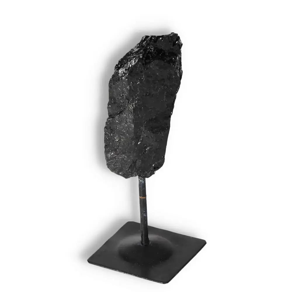 Rough Black Tourmaline with Metal Stand S from Sylvia Crystals, cleanses and purifies energies, enhancing environments with raw beauty.