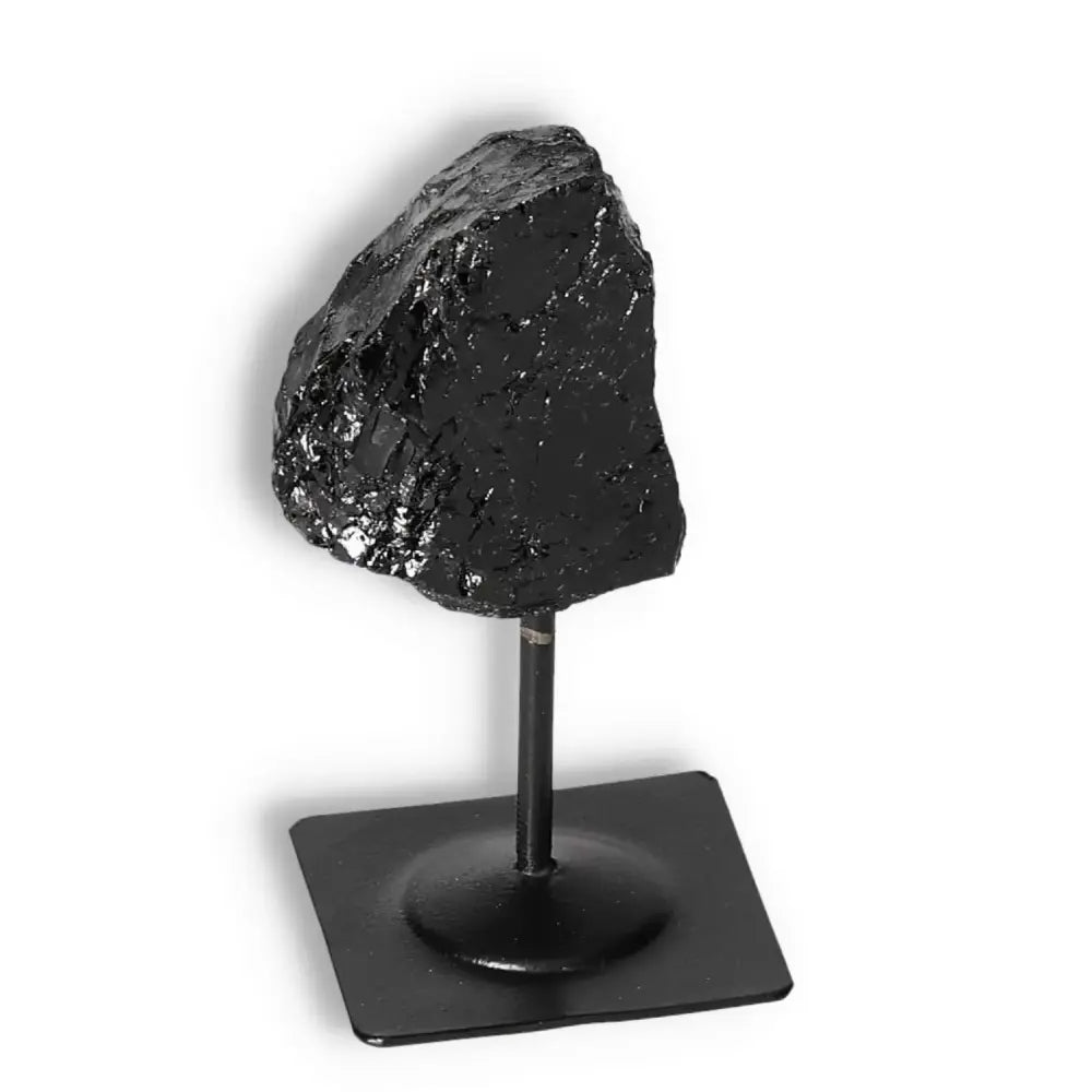 Elegant Rough Black Tourmaline on metal stand, by Sylvia Crystals, showcasing transformative energy and natural beauty.
