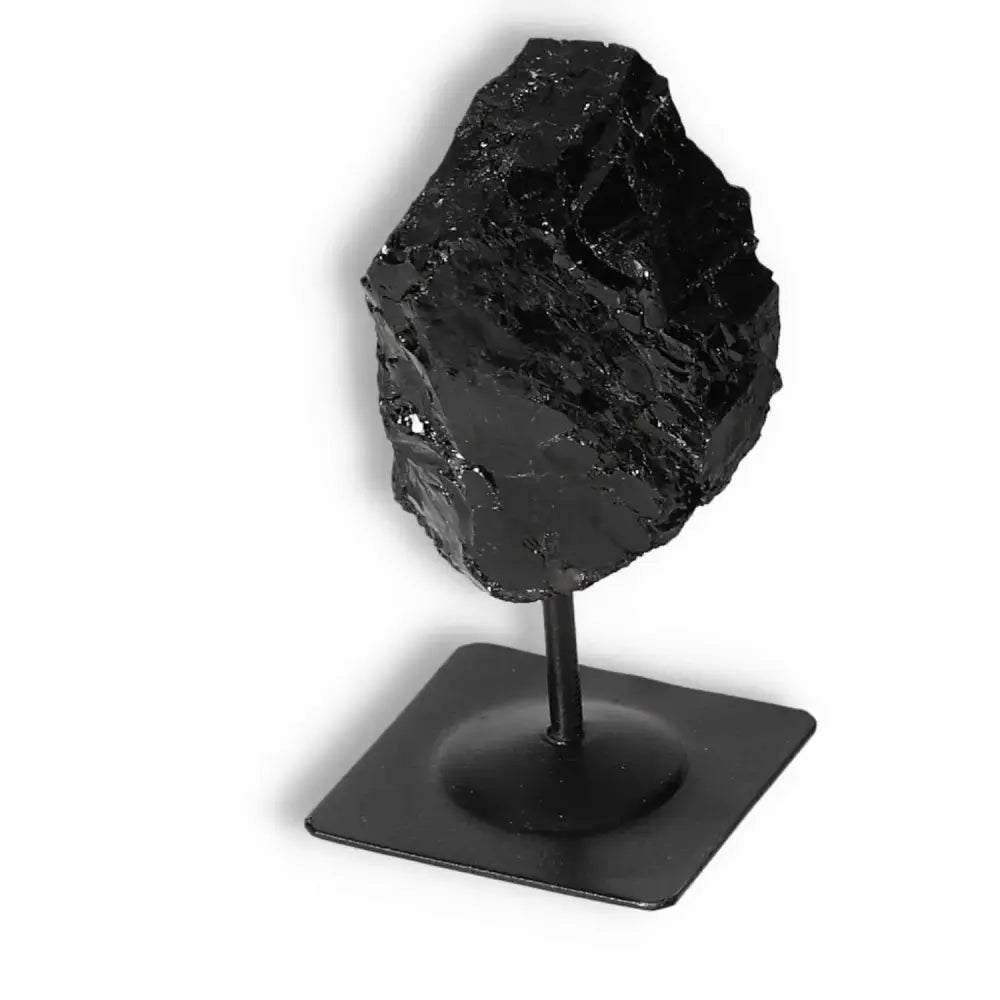 Rough Black Tourmaline on sleek metal stand showcasing elegance and cleansing energy from Sylvia Crystals