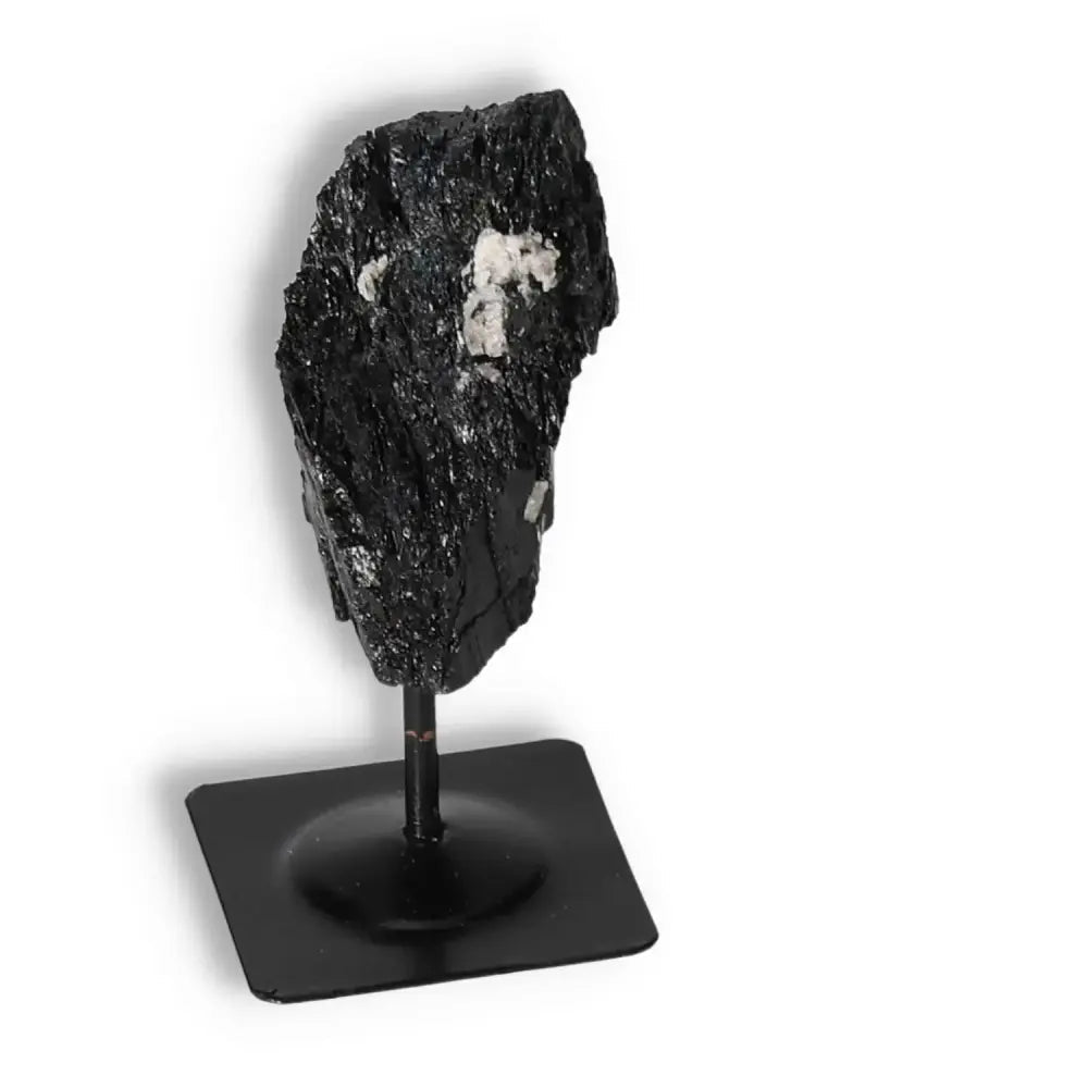 Rough Black Tourmaline on metal stand, premium quality crystal by Sylvia Crystals, known for cleansing and transforming negative energies.
