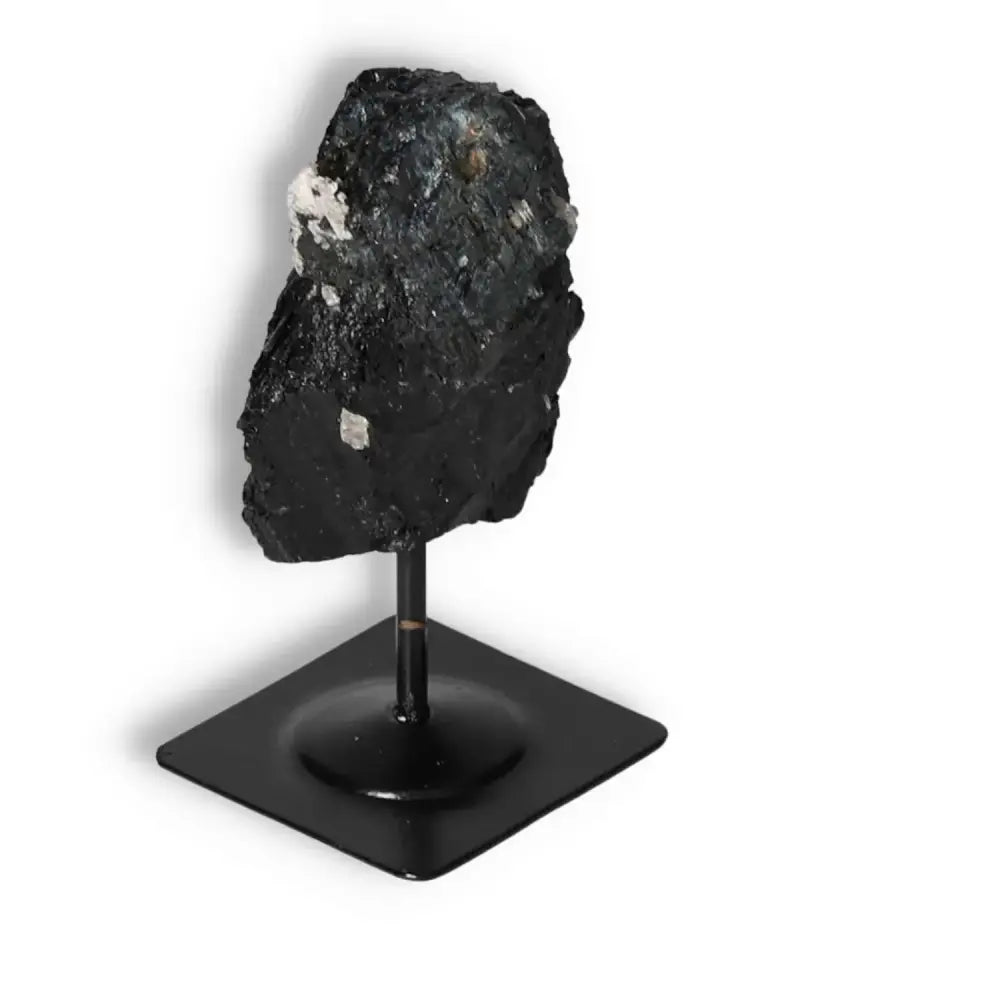 Rough Black Tourmaline on Metal Stand S, known for cleansing properties, sold by Sylvia Crystals.