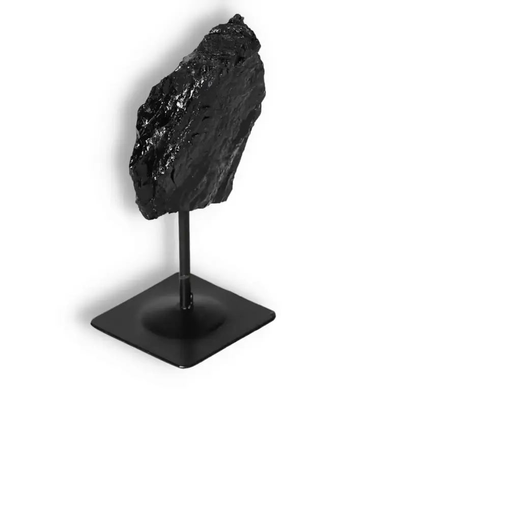 Rough Black Tourmaline on Metal Stand by Sylvia Crystals, known for cleansing negative energies, premium quality crystal decor.