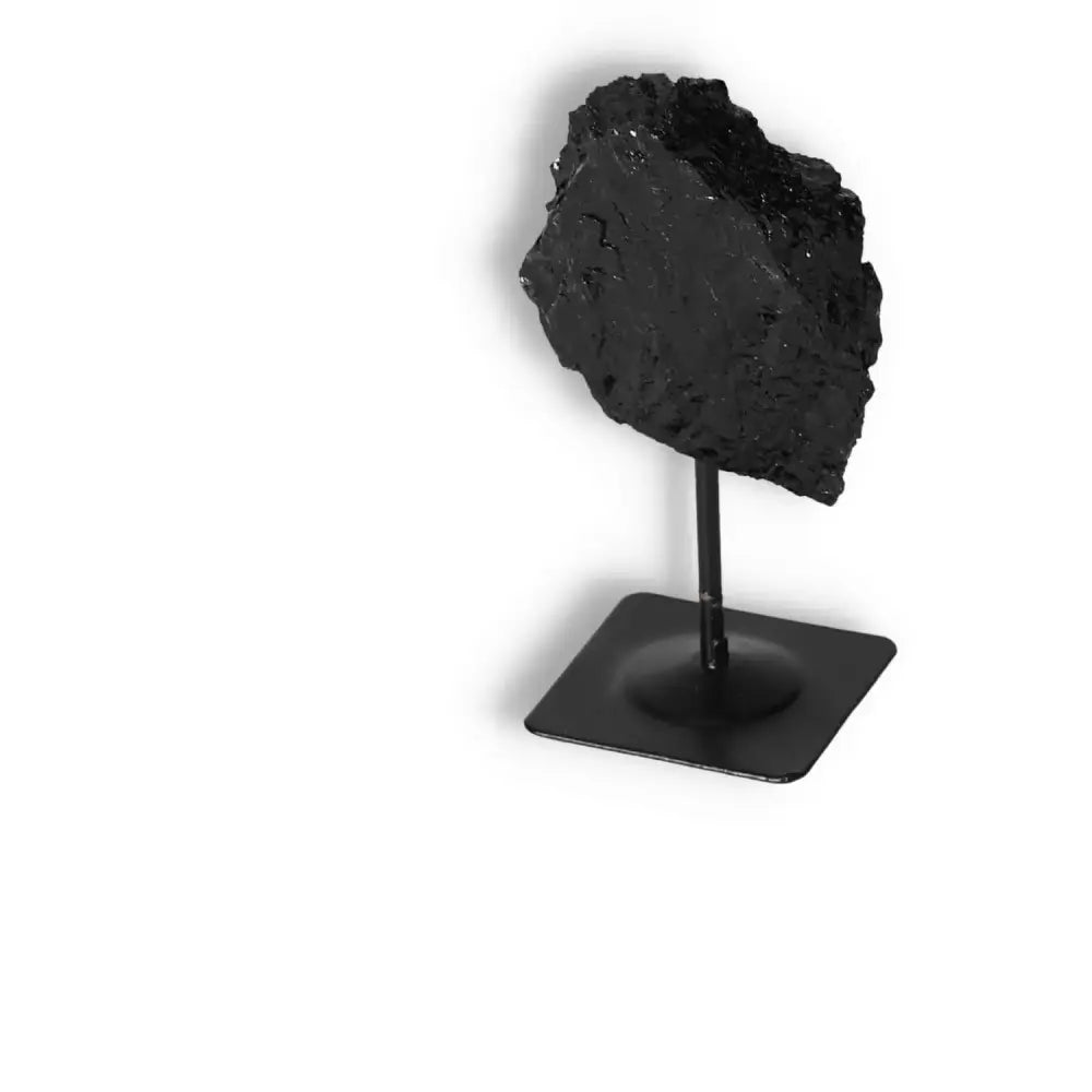 Rough Black Tourmaline on Metal Stand S by Sylvia Crystals, known for cleansing and transforming negative energies.