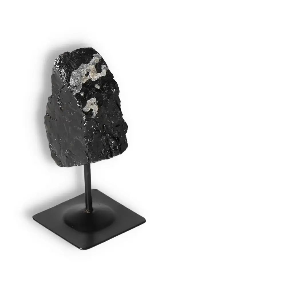 Rough Black Tourmaline on metal stand, ideal for spiritual wellbeing and energy cleansing, luxurious piece by Sylvia Crystals.