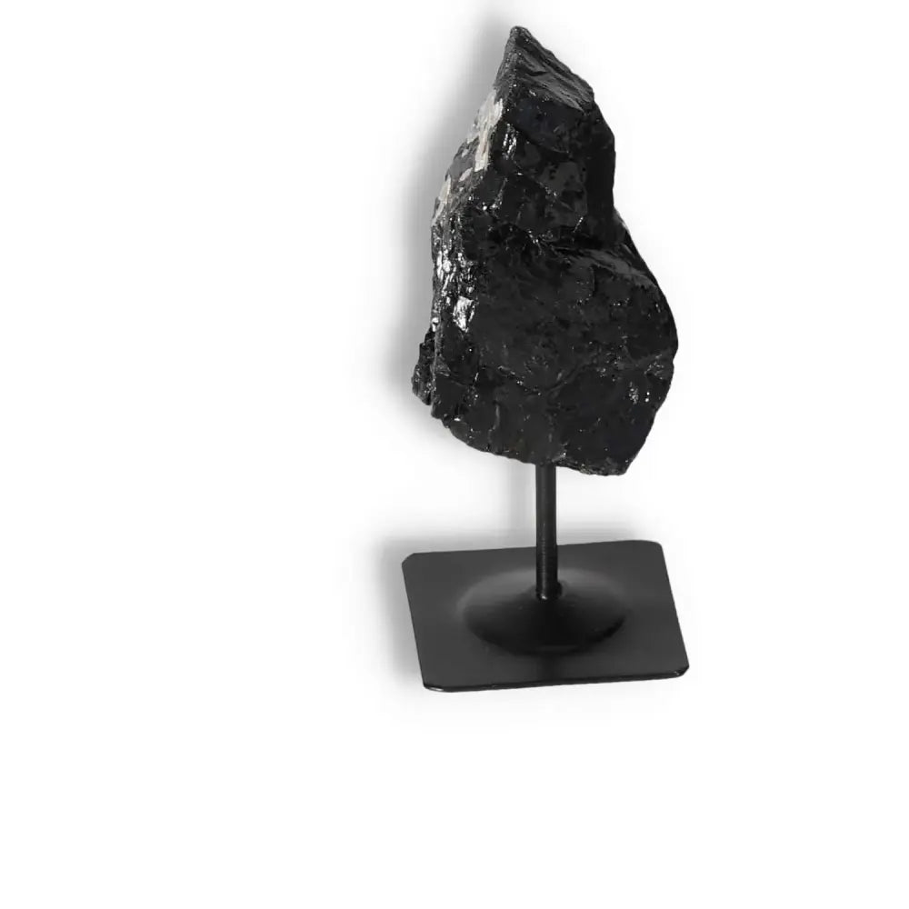 Rough Black Tourmaline on metal stand, premium quality crystal by Sylvia Crystals for cleansing negative energy and spiritual growth.