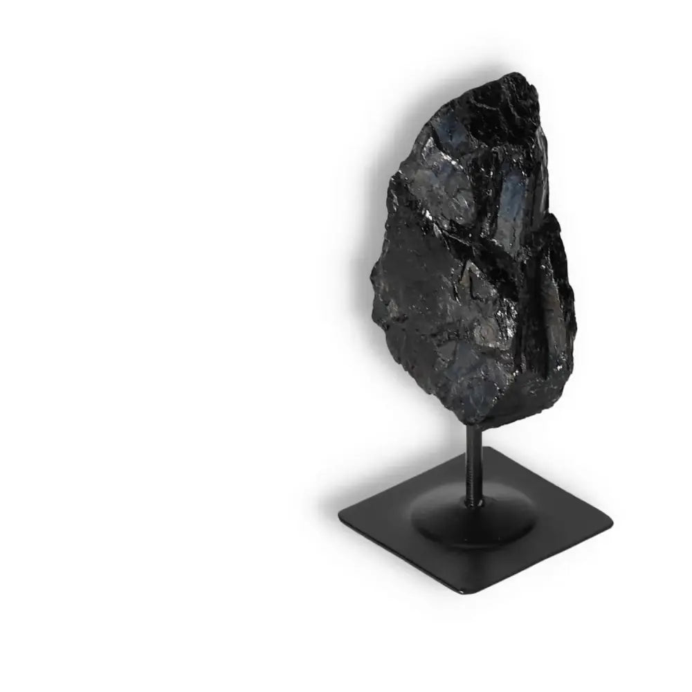 Rough Black Tourmaline on metal stand, luxury crystal by Sylvia Crystals, for energy cleansing and spiritual wellbeing.