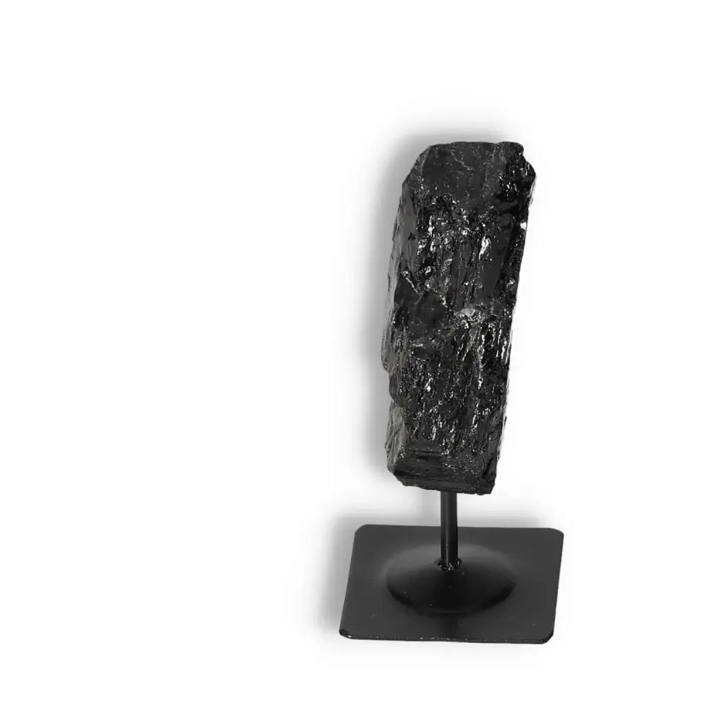 Rough Black Tourmaline on Metal Stand by Sylvia Crystals for spiritual wellbeing and energy cleansing.