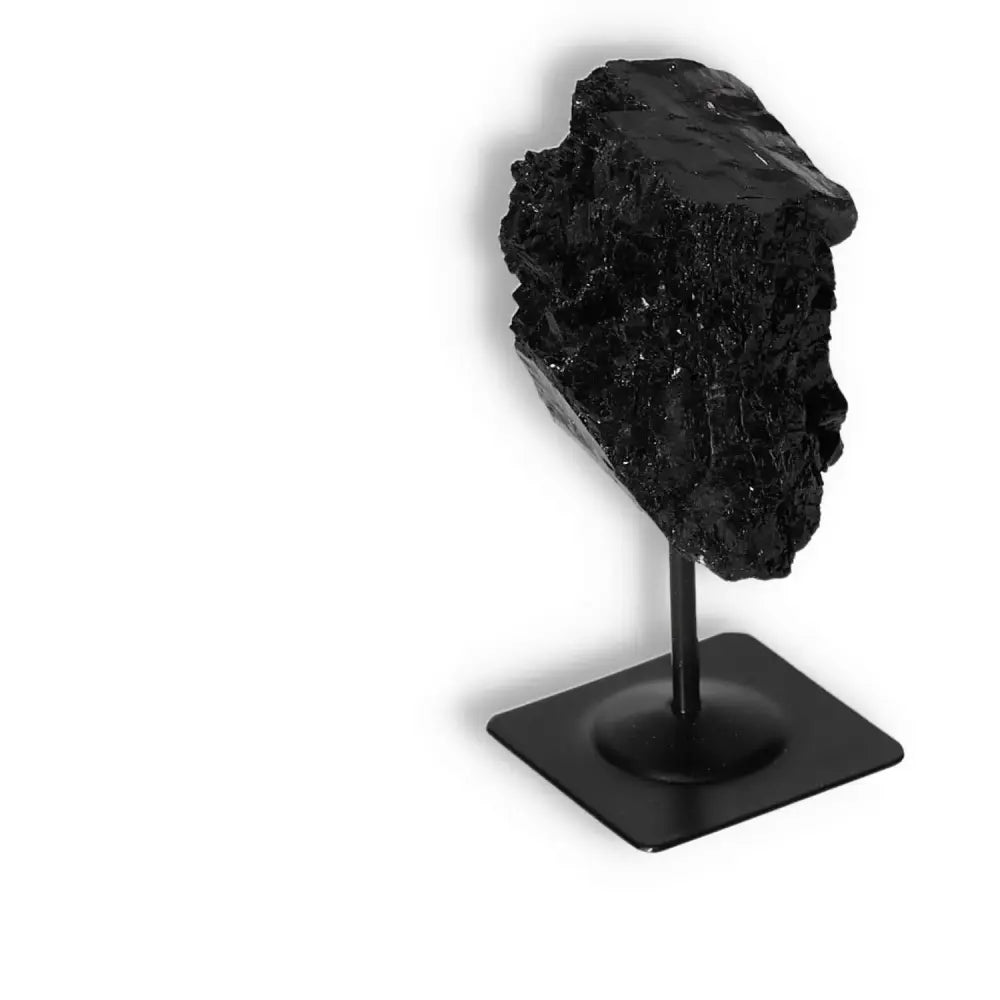 Rough Black Tourmaline with Metal Stand S, known for cleansing negative energies and promoting spiritual grounding, from Sylvia Crystals.