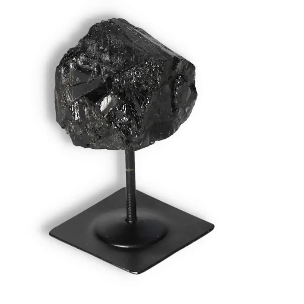 Rough Black Tourmaline on Metal Stand by Sylvia Crystals for spiritual energy cleansing and grounding.