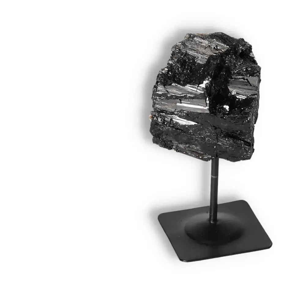 Rough Black Tourmaline with Metal Stand S by Sylvia Crystals, known for transforming negative energies and enhancing balance.