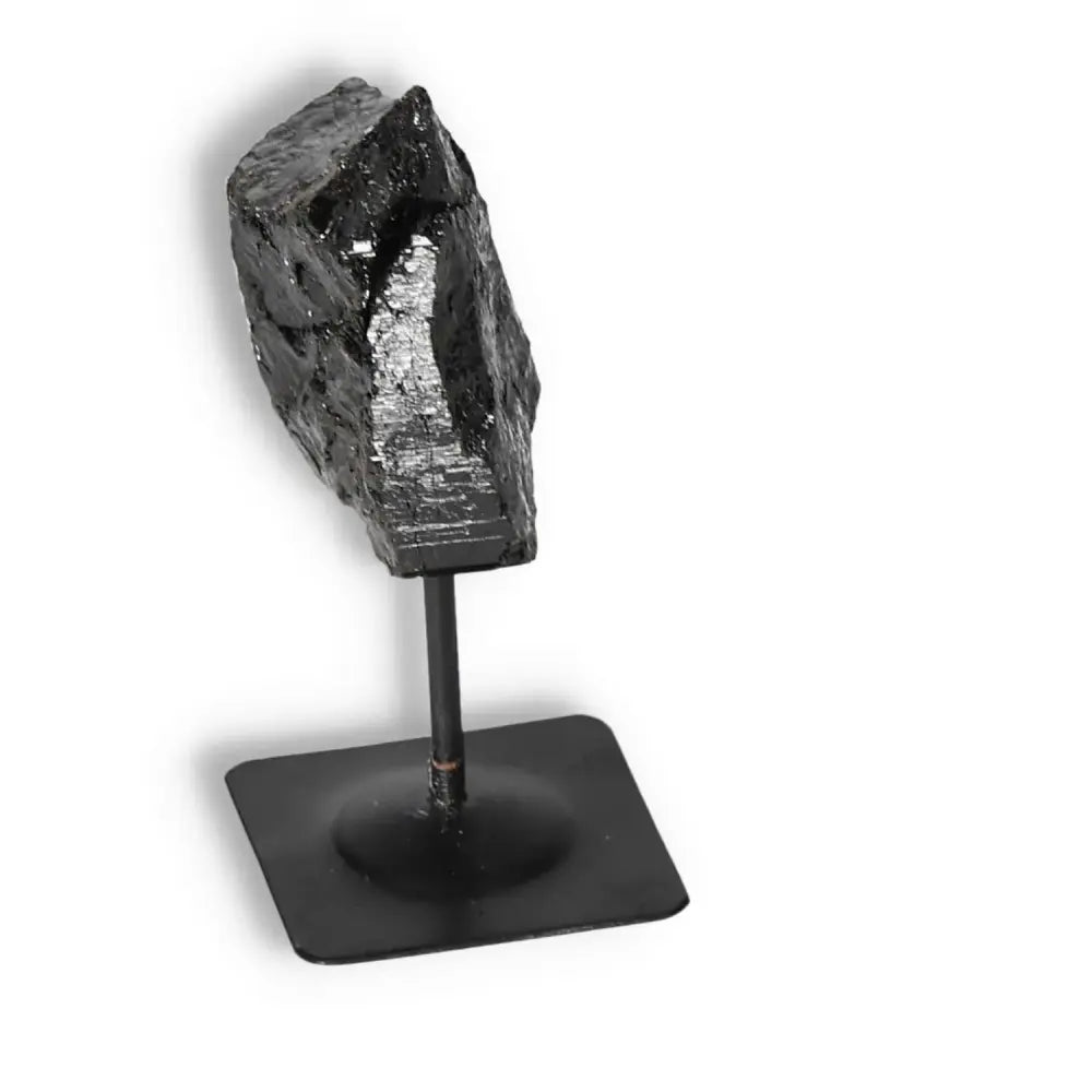 Rough Black Tourmaline with Metal Stand by Sylvia Crystals, perfect for home decor and spiritual enhancement.
