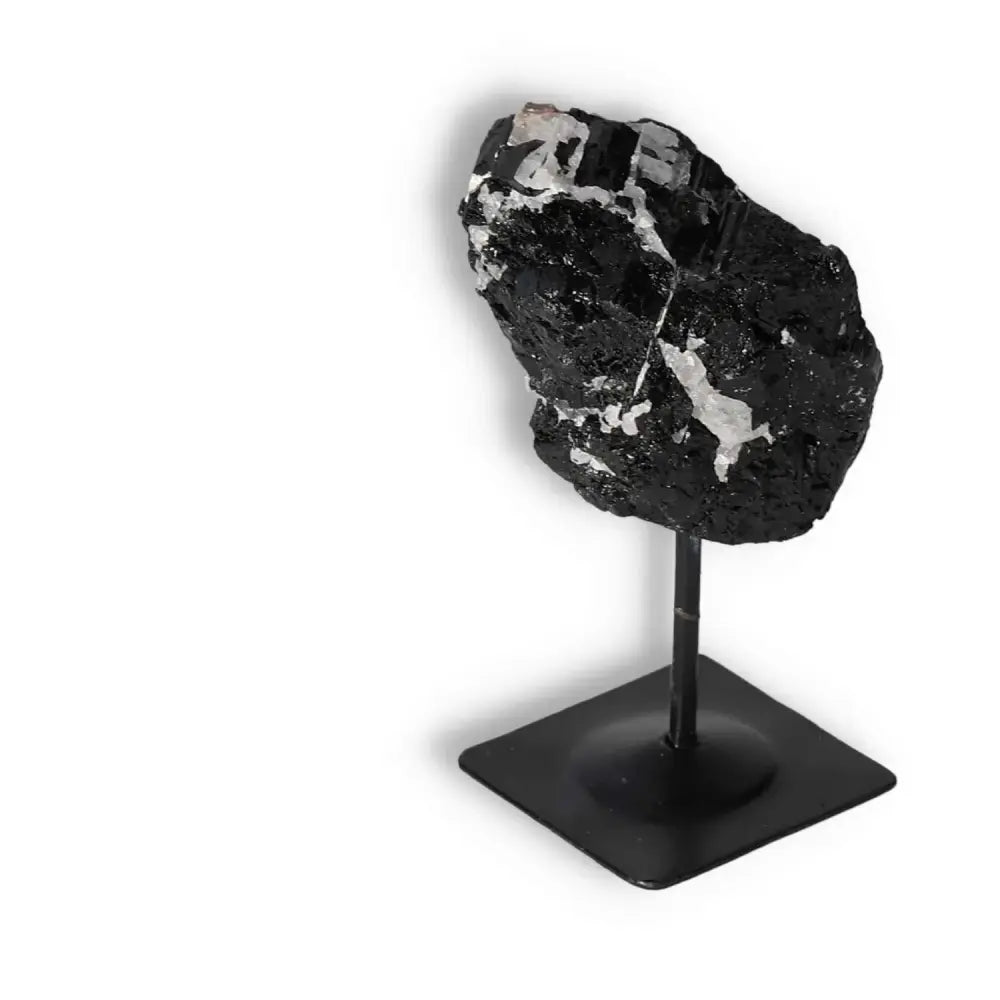Rough Black Tourmaline on Metal Stand S from Sylvia Crystals, known for cleansing negative energies, exquisitely displayed.