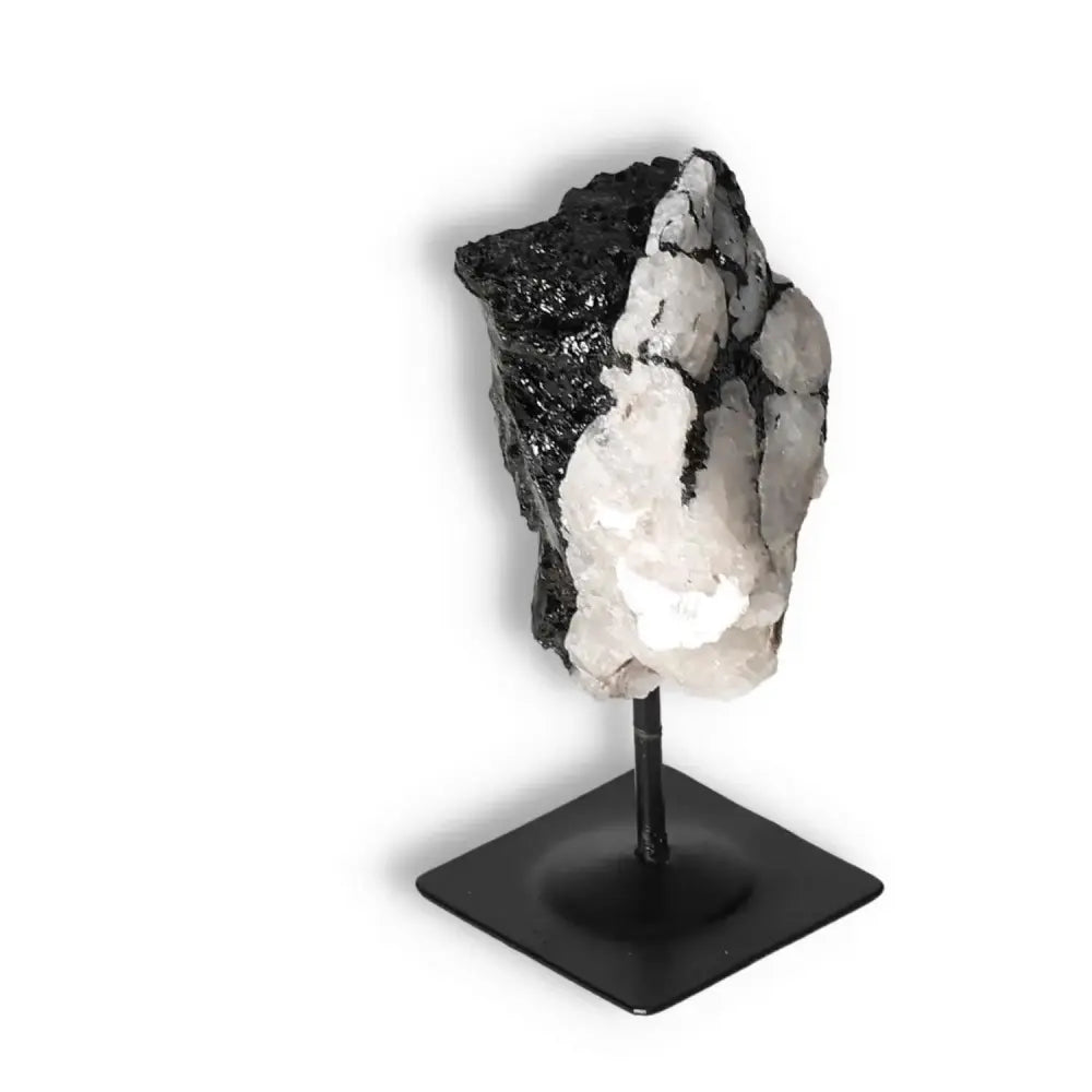 Rough Black Tourmaline crystal with metal stand, offering elegance and spiritual depth from Sylvia Crystals. Ideal for healing and grounding.