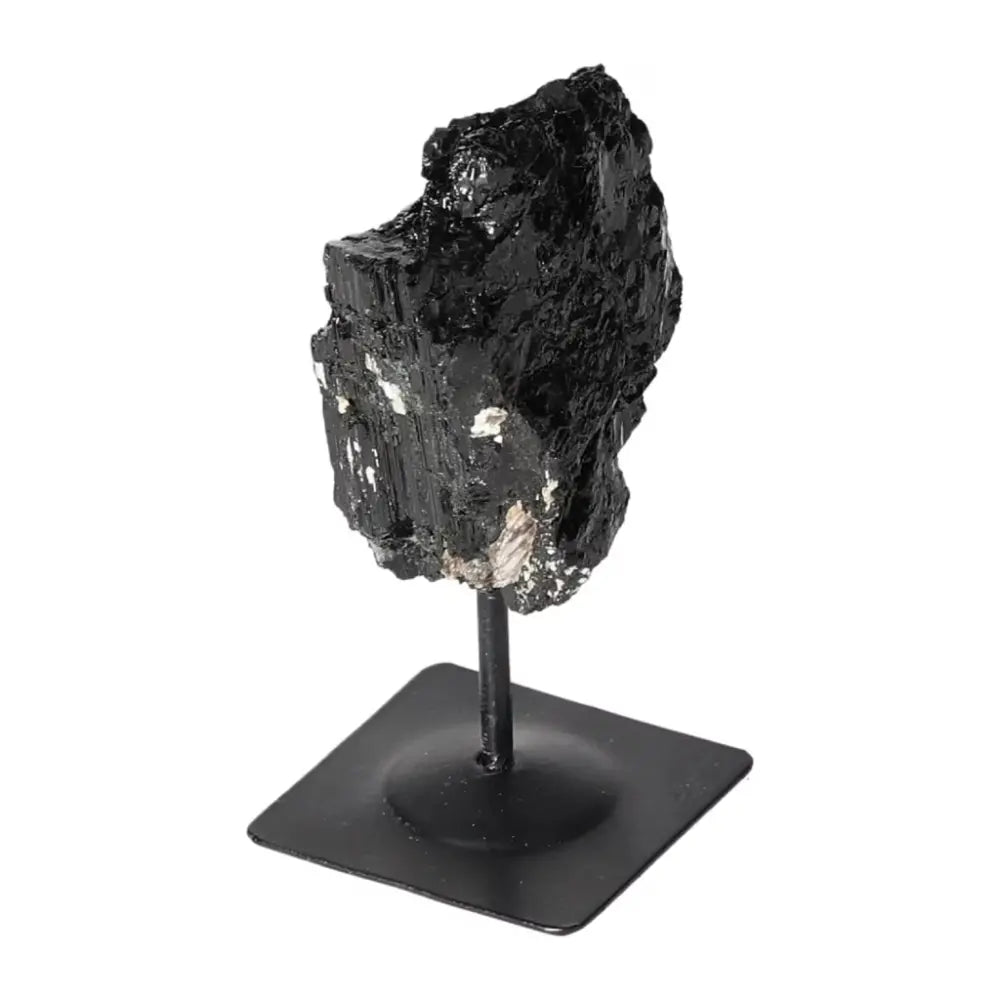 Rough Black Tourmaline on metal stand, showcasing natural beauty. Premium crystal from Sylvia Crystals for cleansing negative energies.
