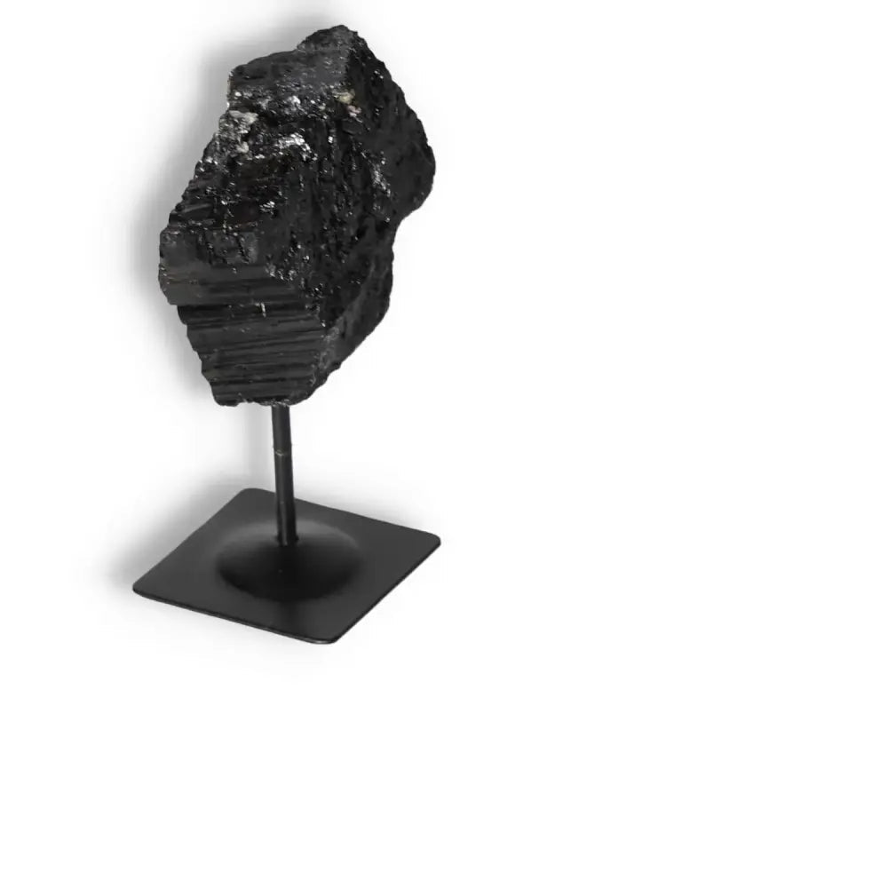 Rough Black Tourmaline with Metal Stand S by Sylvia Crystals, known for grounding and energy purification, showcased on a stand.