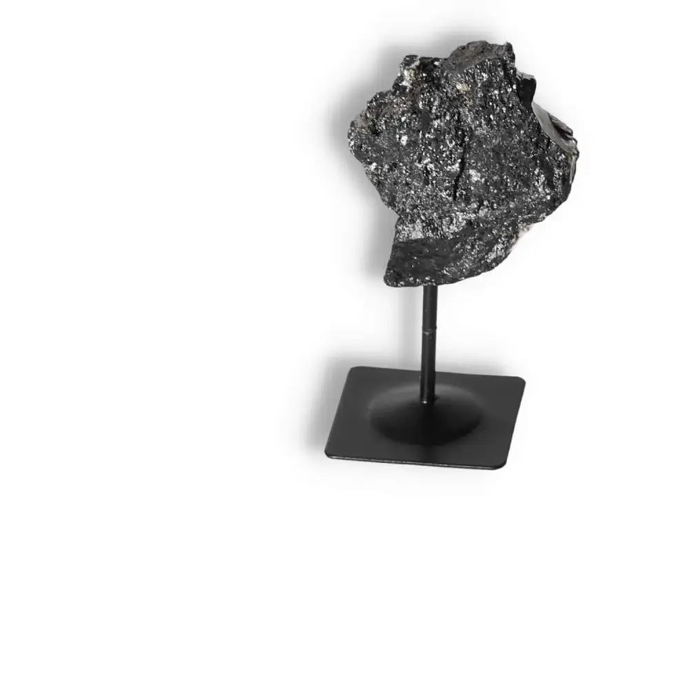 Rough Black Tourmaline with Metal Stand by Sylvia Crystals, a powerful grounding gemstone for purifying and transformative energy.