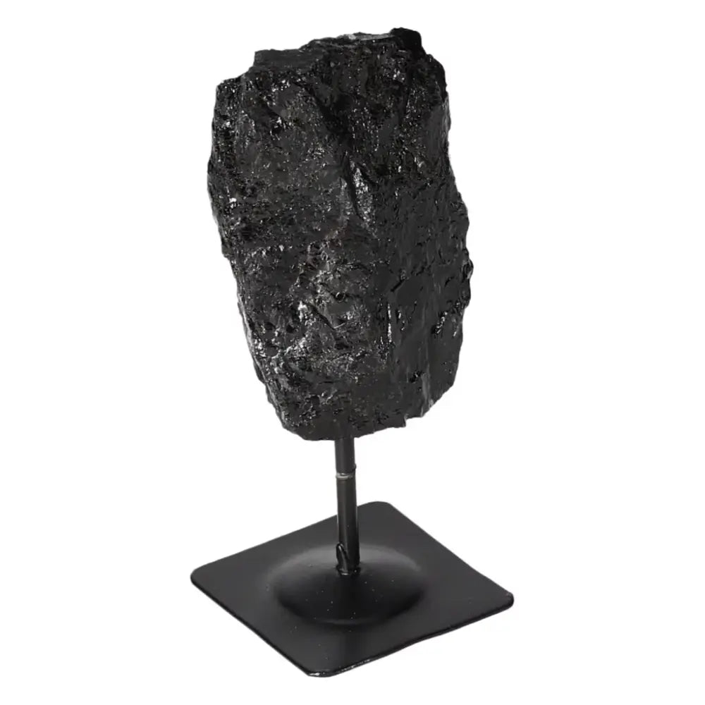 Rough Black Tourmaline on metal stand, offering powerful cleansing energy and grounding properties, ideal for promoting mental balance.