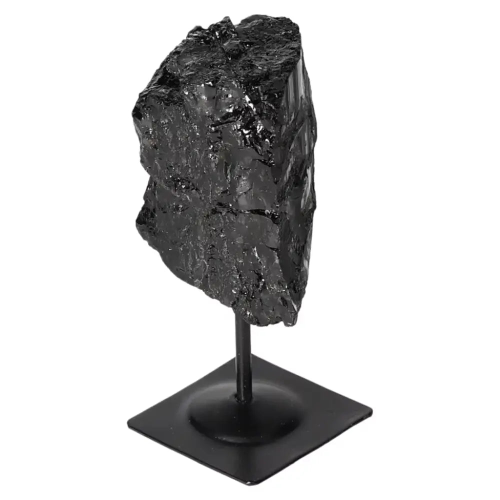 Rough Black Tourmaline on metal stand, perfect for energy cleansing and grounding, enhances root chakra and concentration.