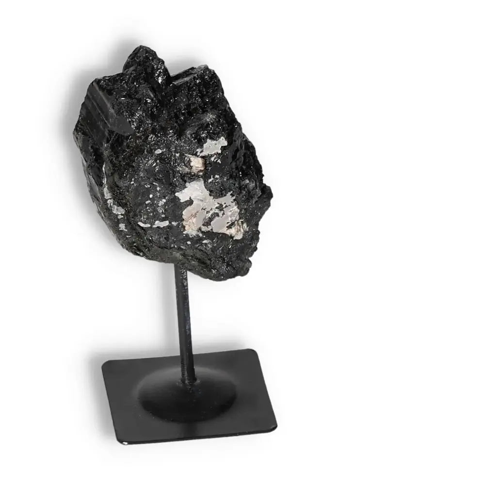 Rough Black Tourmaline on metal stand from Sylvia Crystals, for energy cleansing and protection in modern interiors.