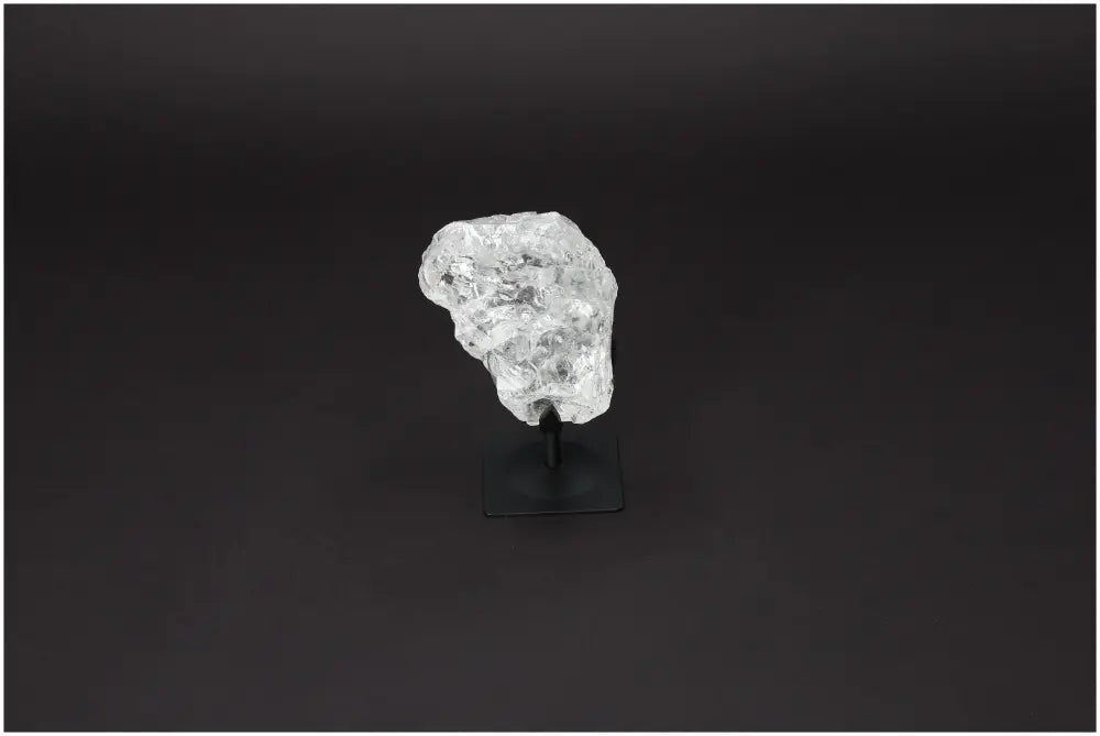 Rough Clear Quartz on Metal Stand by Sylvia Crystals, exhibiting natural beauty and luxury, known for purification properties.