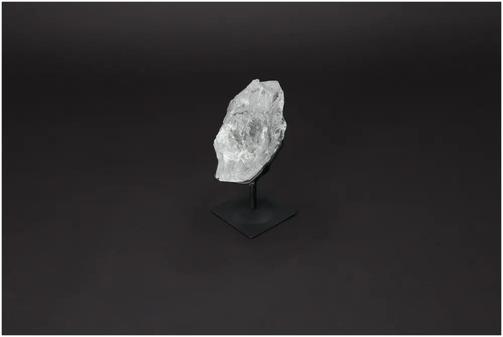 Rough Lemurian Quartz on metal stand, showcasing natural elegance and spiritual depth, by Sylvia Crystals.