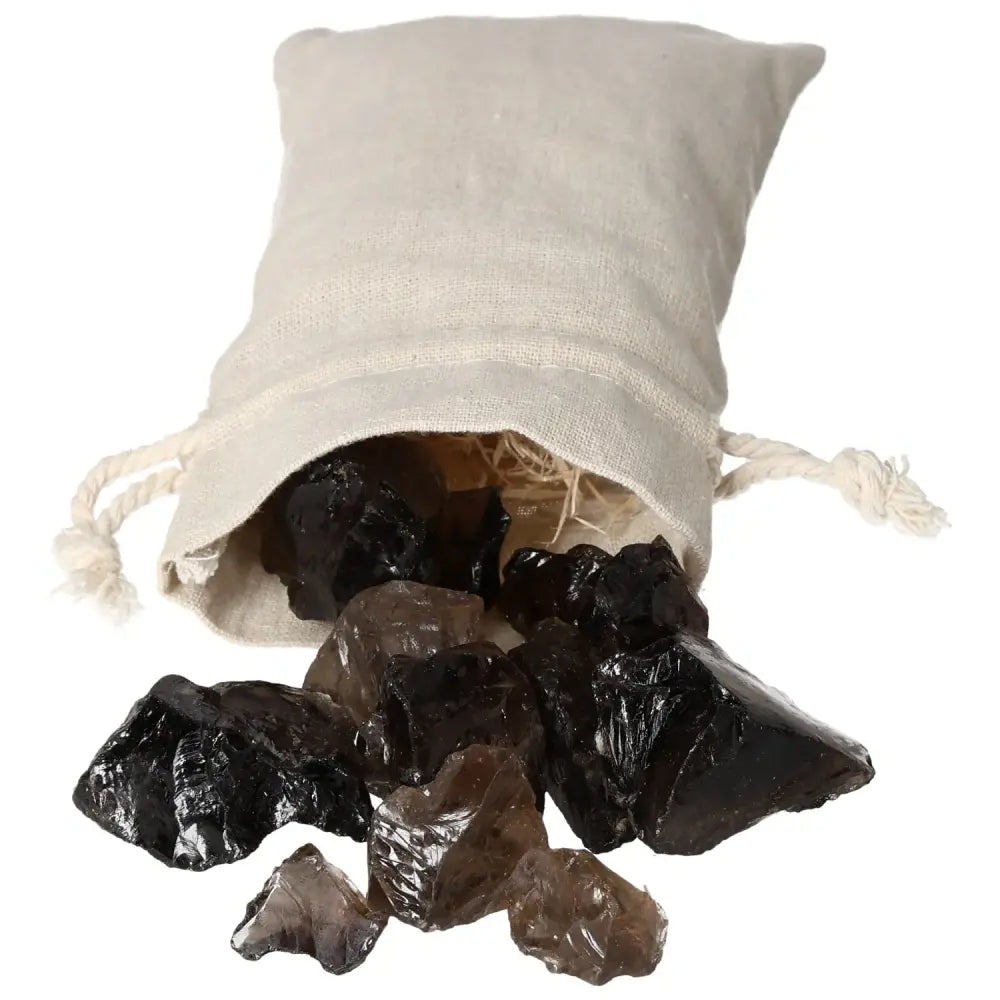Rough Smoky Quartz crystals spilling from a beige drawstring pouch, showcasing their earthy tones and natural formation.