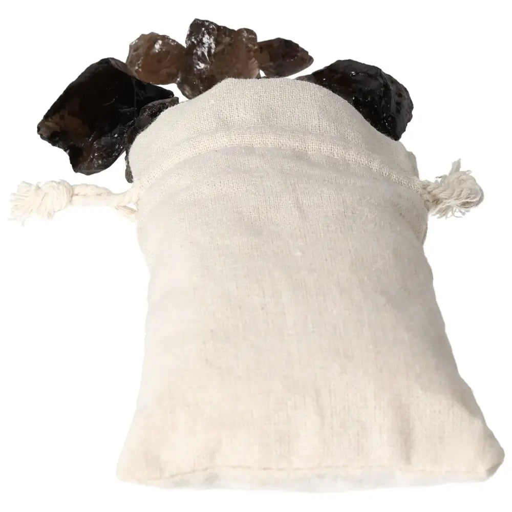 Silk pouch holding Sylvia Crystals' Rough Smoky Quartz, known for grounding and clarity-enhancing properties, premium gemstone display.