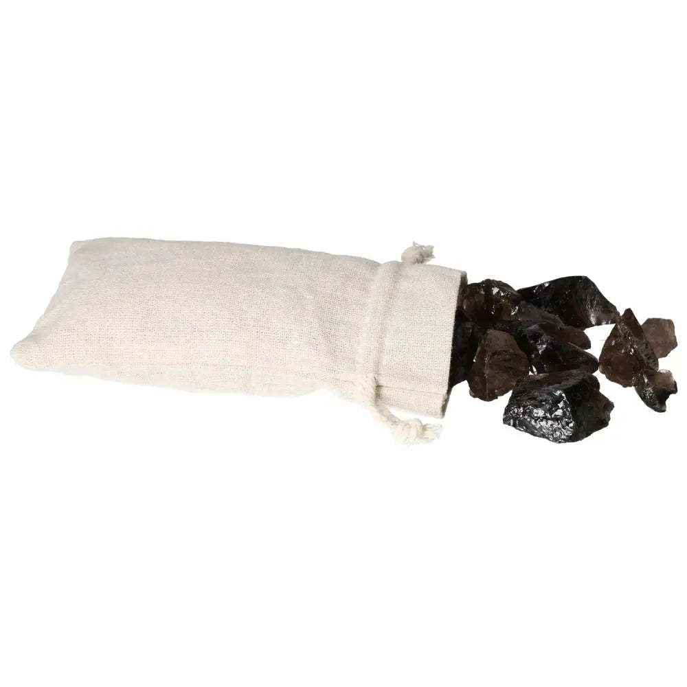 Rough Smoky Quartz gemstones spilling from a fabric bag, showcasing the natural beauty and grounding energy of the stones.