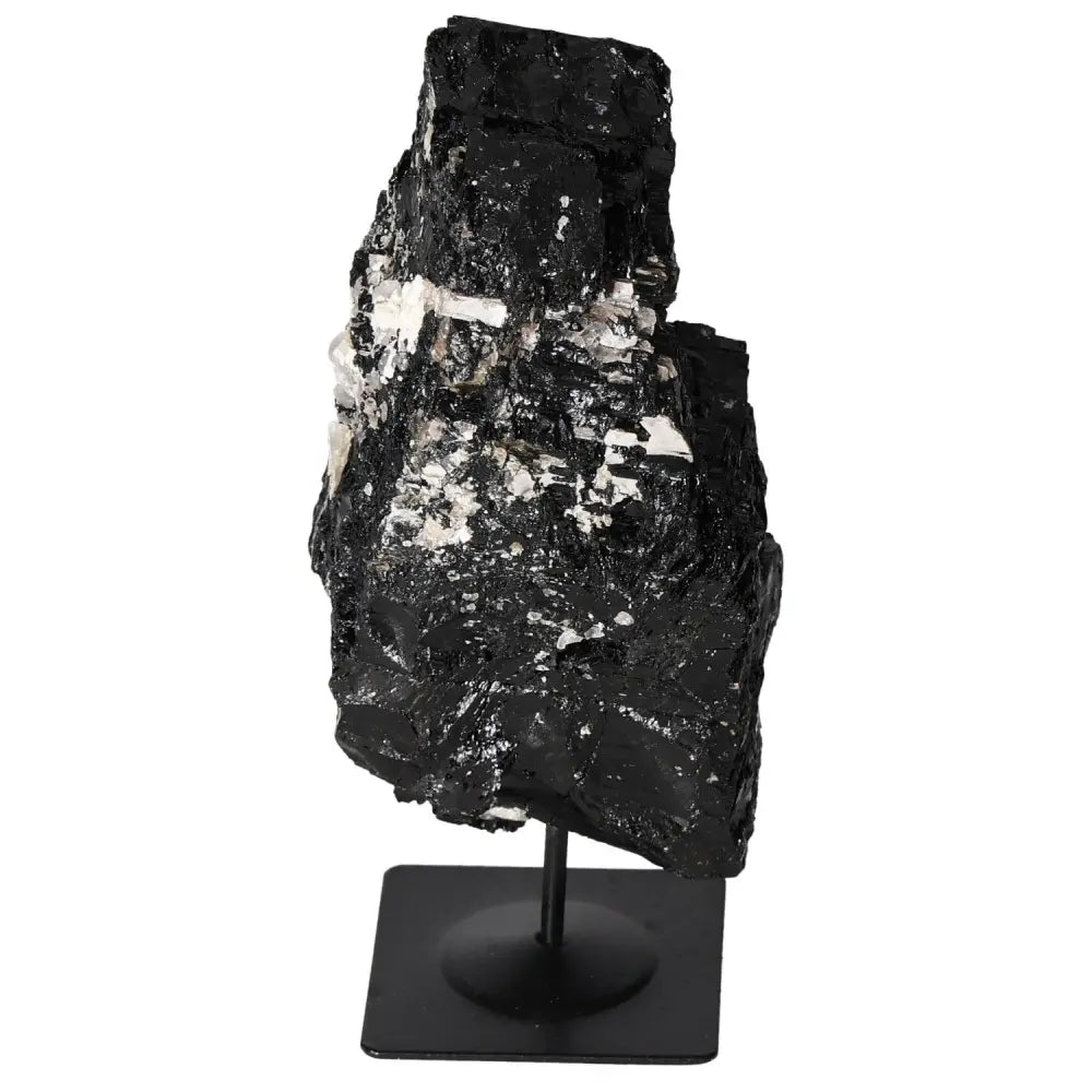 Rough Tourmaline on metal stand, showcasing vibrant hues and unique formations, perfect for interior decor and spiritual harmony.