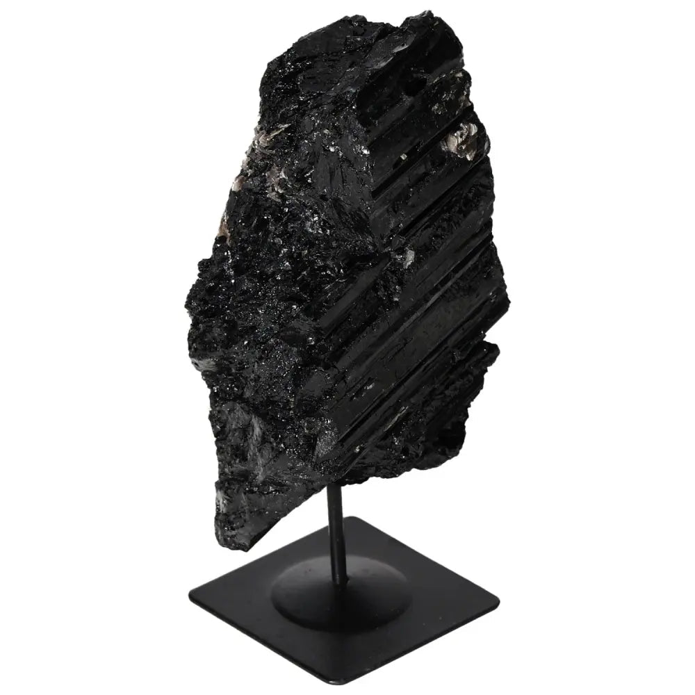 Rough black tourmaline on metal stand, showcasing natural elegance and vibrant hues, perfect for home decor and spiritual harmony.
