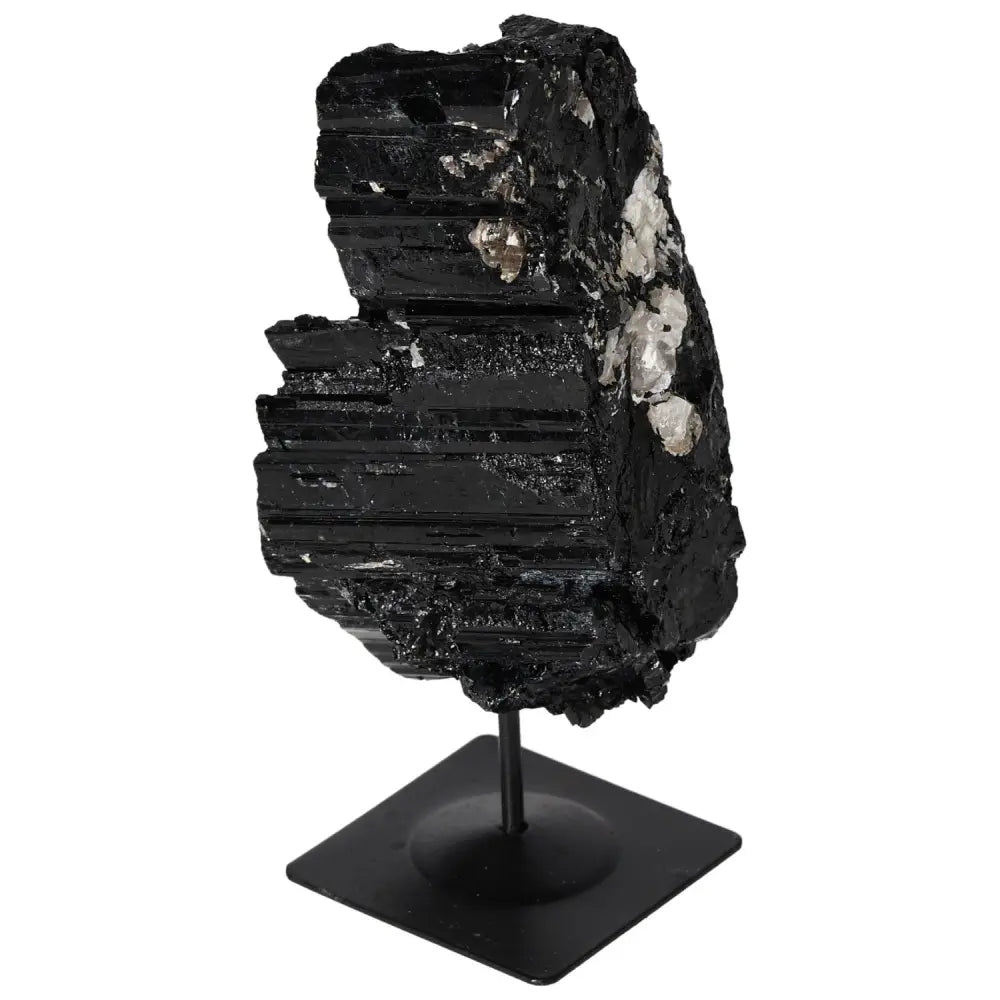 Elegant rough tourmaline crystal on metal stand, perfect for interior decor and spiritual harmony from Sylvia Crystals.