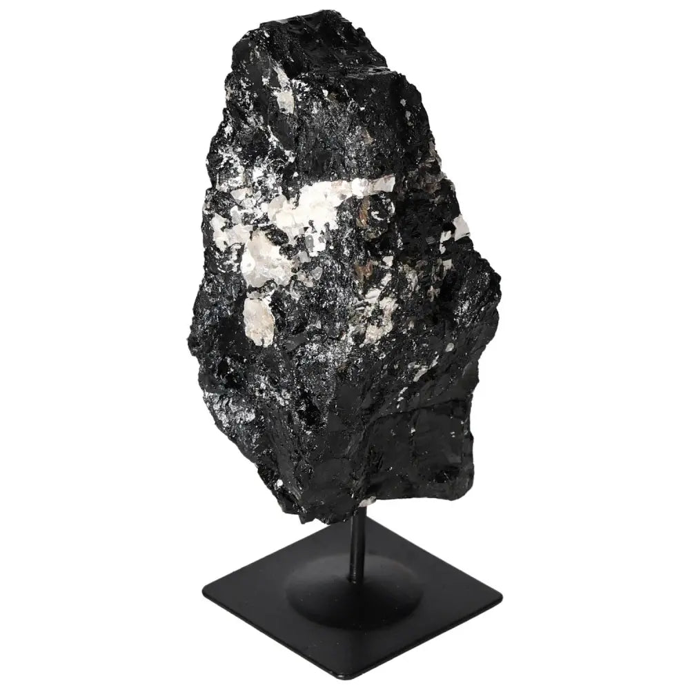 Elegant black rough tourmaline crystal with unique formations on a metal stand by Sylvia Crystals, enhancing interior elegance.
