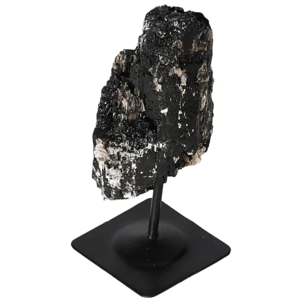 Rough tourmaline crystal on metal stand by Sylvia Crystals, showcasing natural elegance and luxury in home decor.
