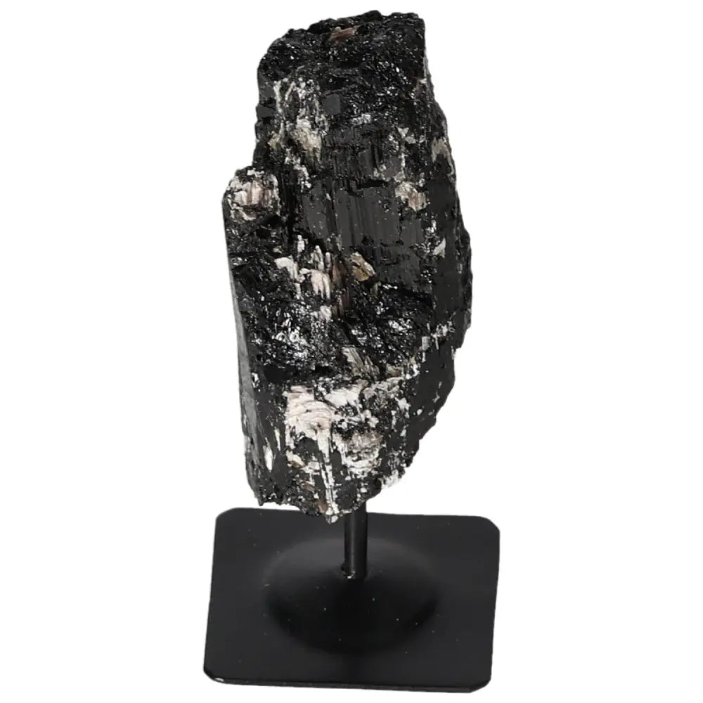 Rough tourmaline crystal on a sleek metal stand from Sylvia Crystals, combining natural elegance with modern design for a sophisticated display.