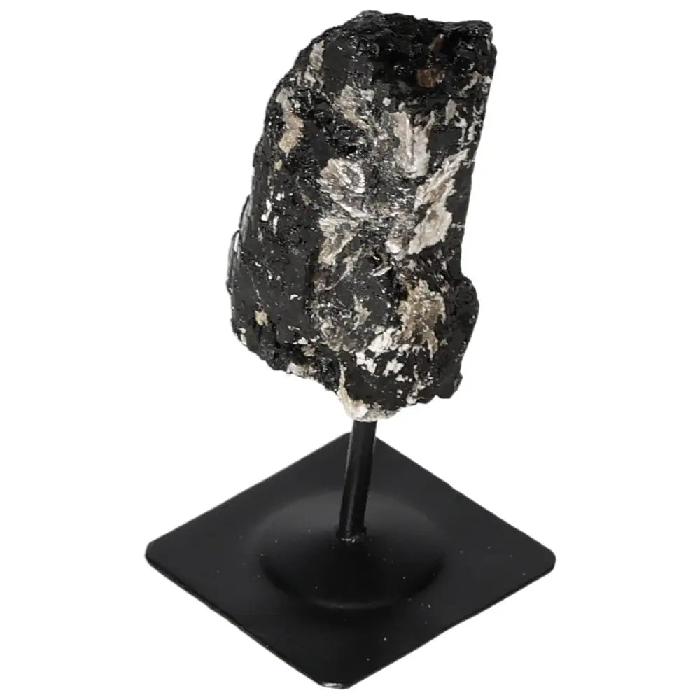 Rough tourmaline crystal on sleek metal stand, showcasing natural elegance and sophisticated design by Sylvia Crystals.