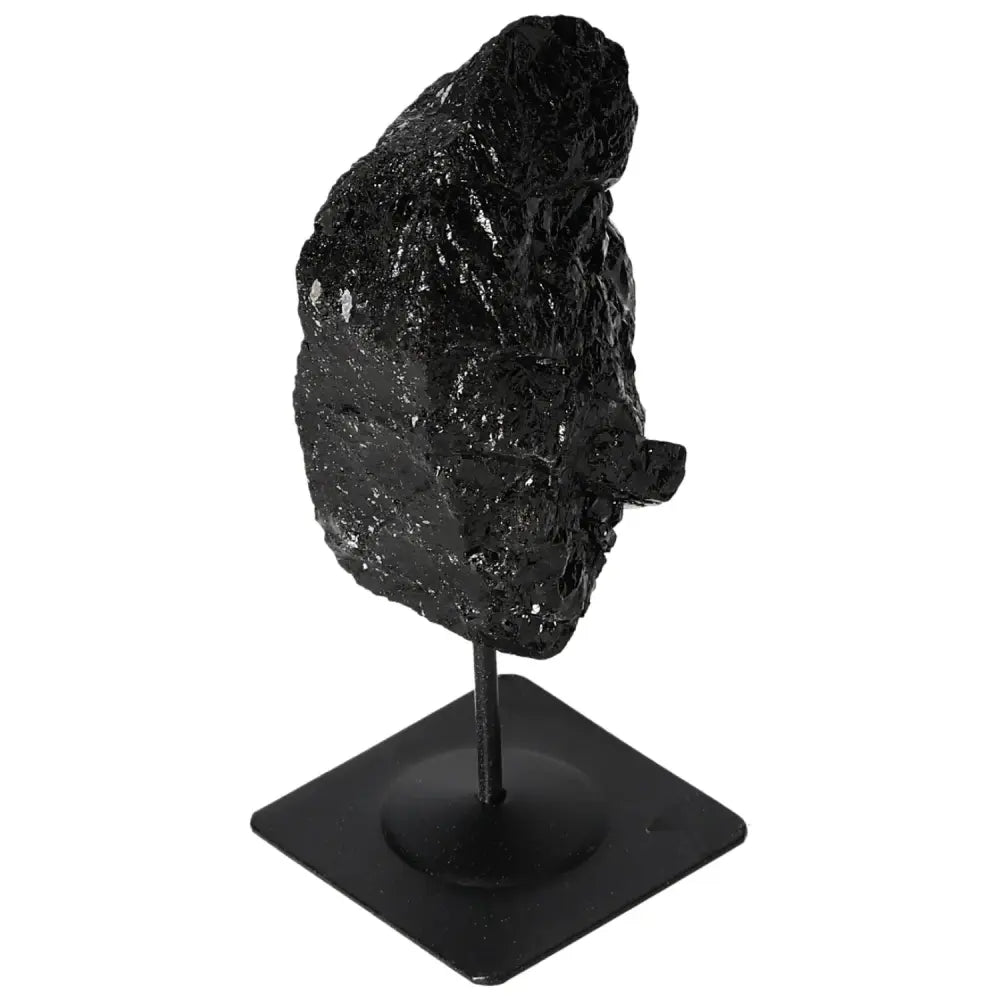Rough black tourmaline crystal on metal stand from Sylvia Crystals. Ideal for home decor or as a unique gift piece.