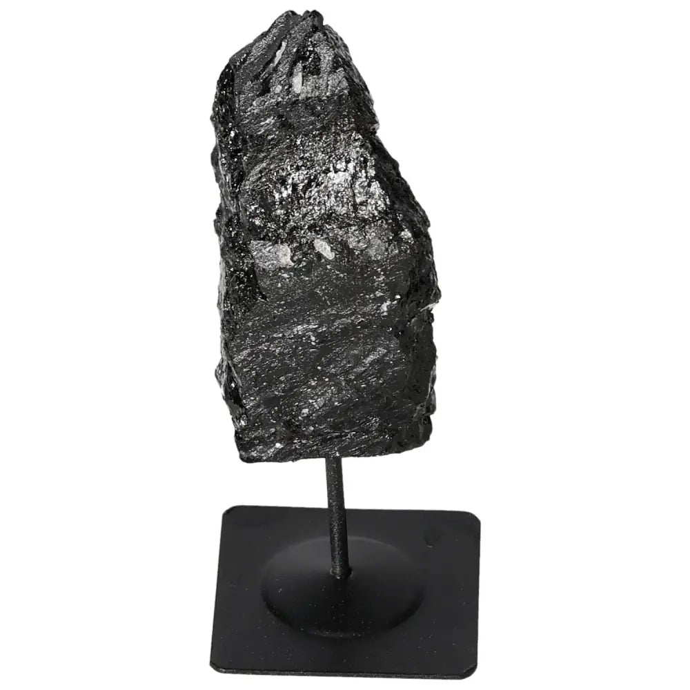 Rough black tourmaline on metal stand, showcasing natural charm and diverse colors, premium selection from Sylvia Crystals.